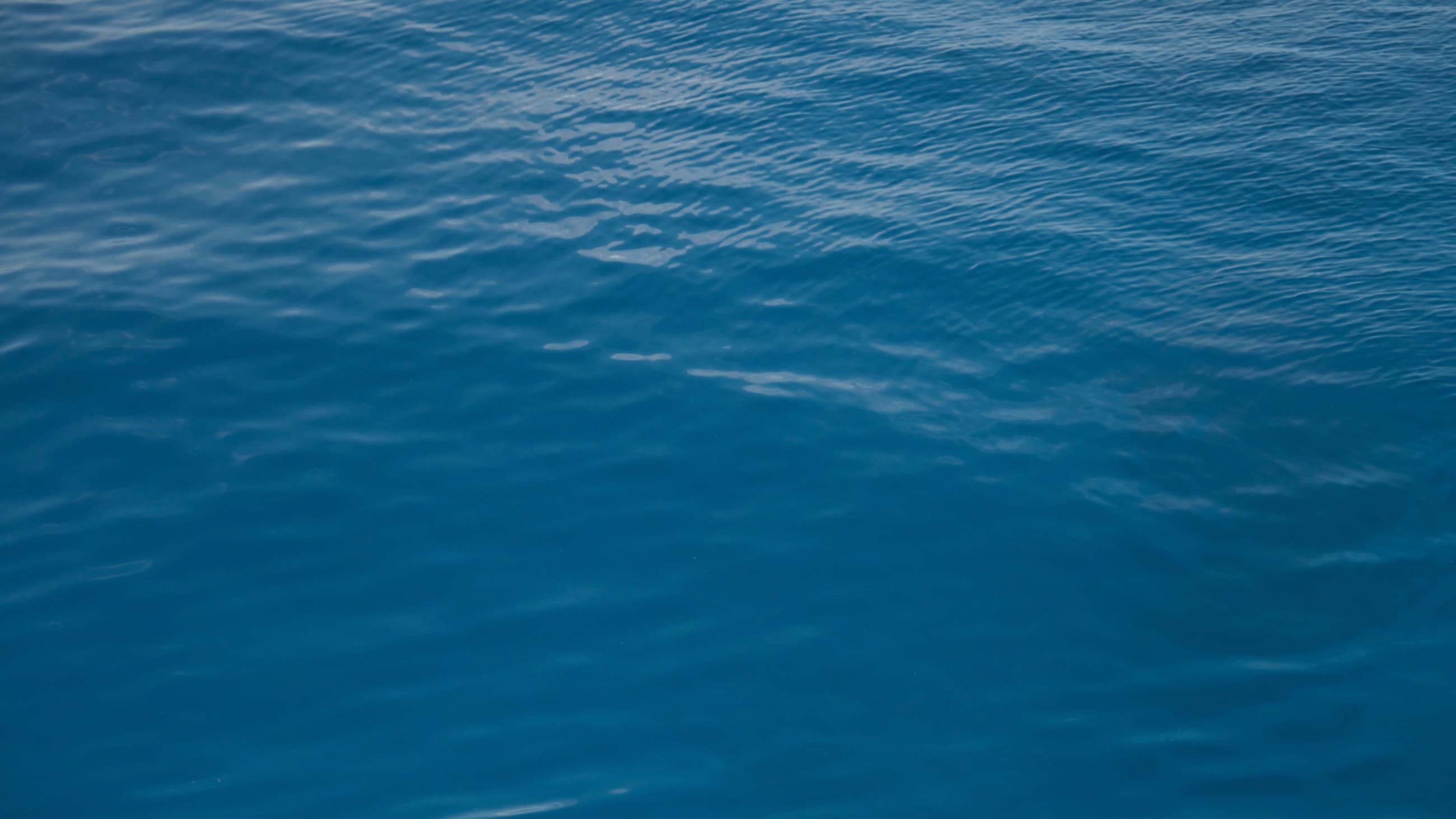 Deep blue open ocean water, evoking Sir Peter Blake's seafaring legacy