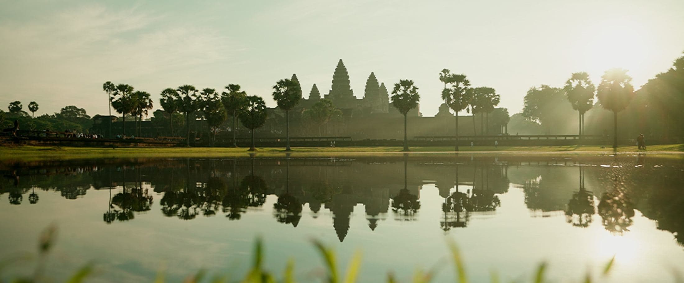Angkor Wat reflected in water at sunset, Cambodia