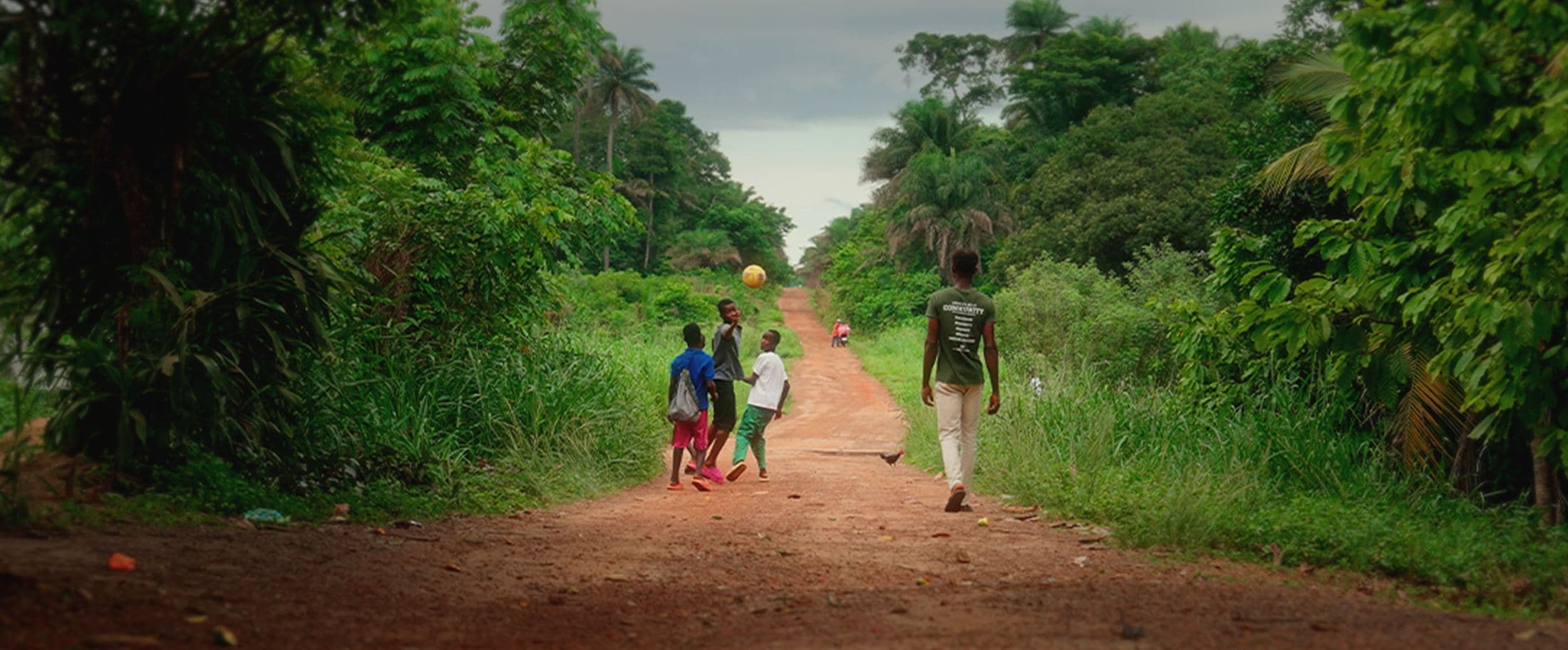 Children walking down a dirt road, Sierra Leone