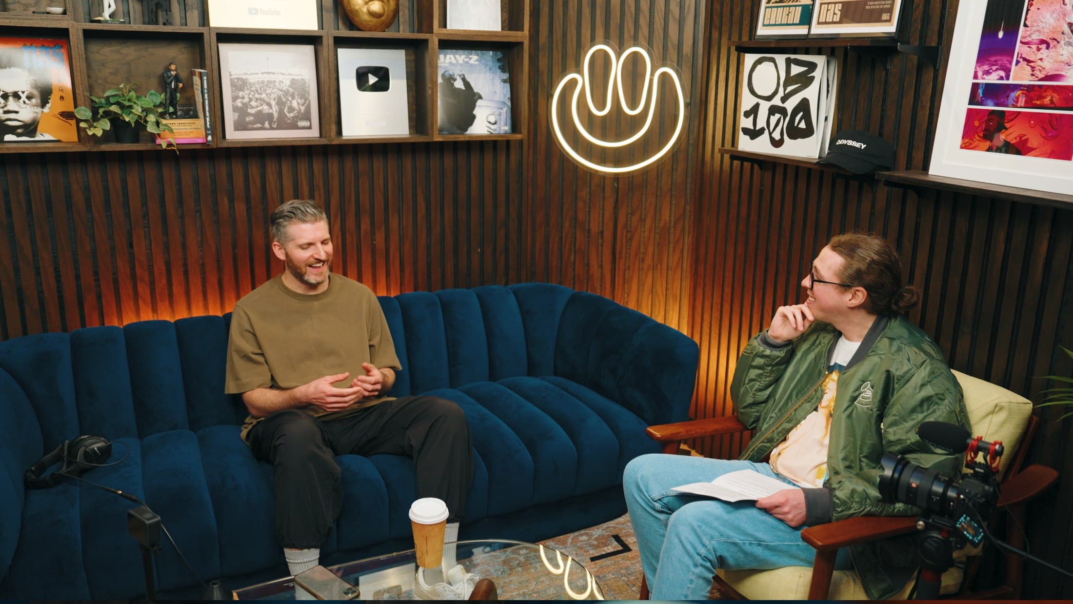 Liam McEwan interviewing Harry Mack in a dressed studio set, Los Angeles