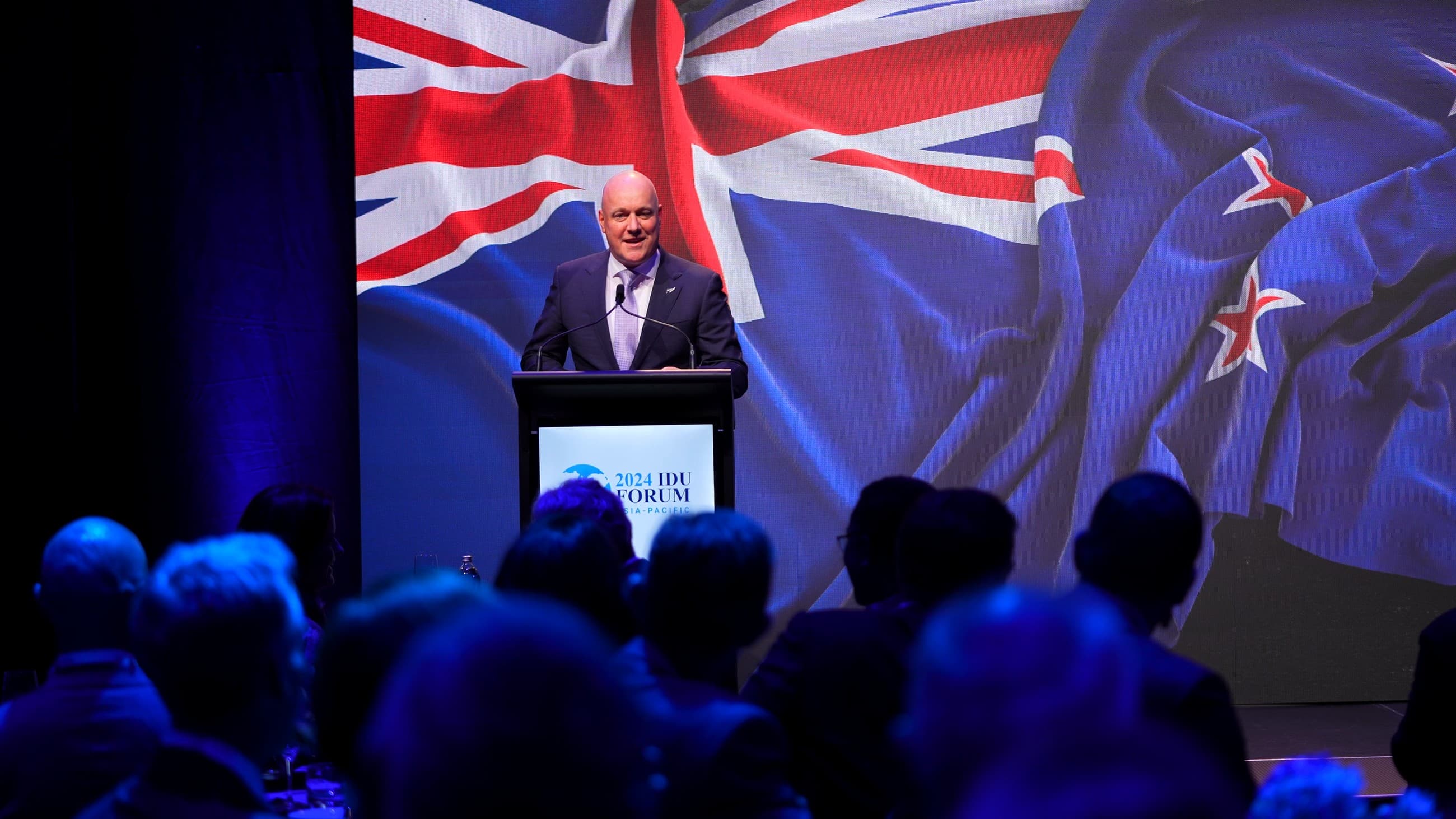 A speaker addressing the 2024 IDU Forum Asia-Pacific from the keynote stage