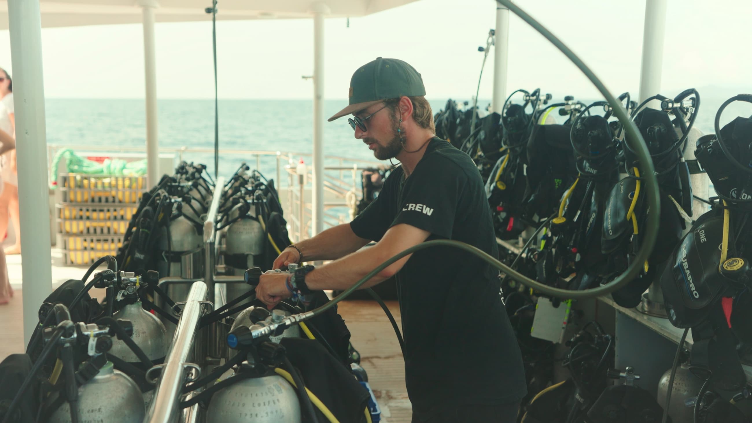A research diver preparing gear aboard a boat