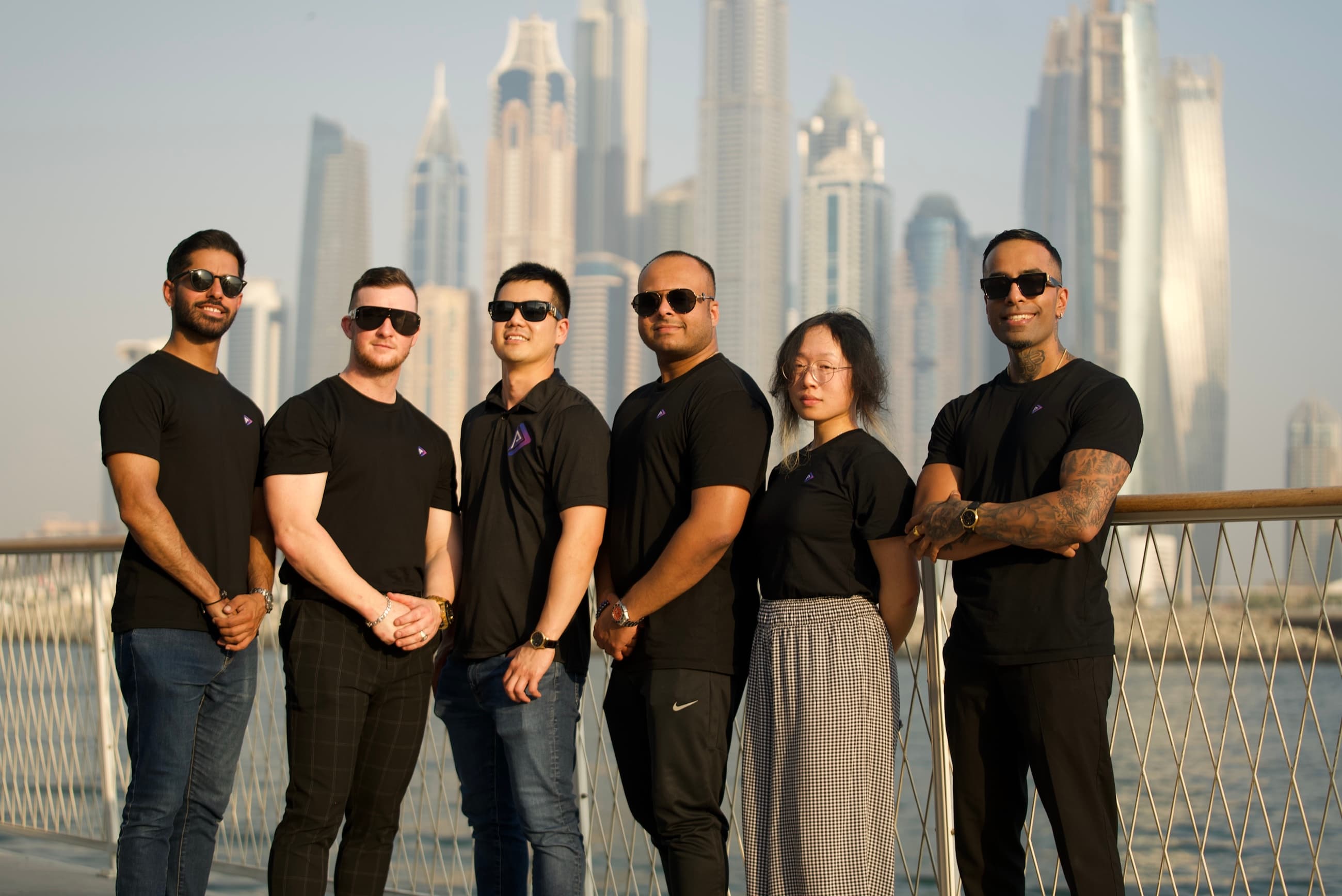 The Presence team lined up along the Dubai Marina waterfront