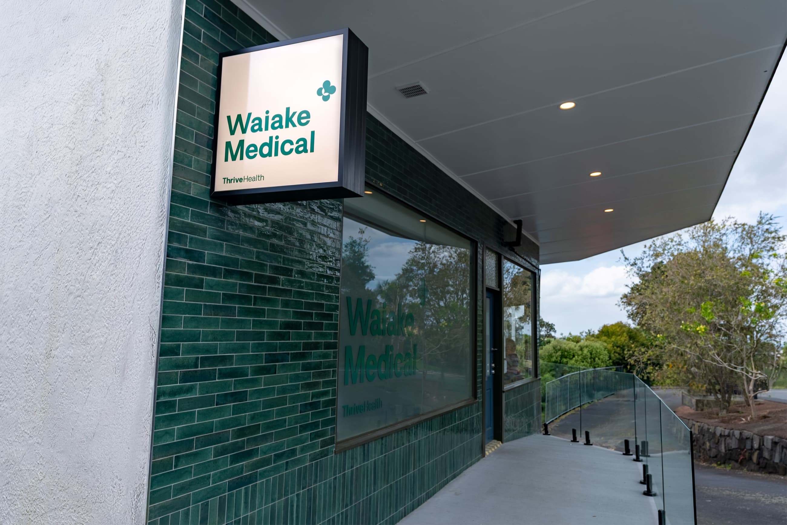 Waiake Medical signage on the clinic's green-tiled exterior