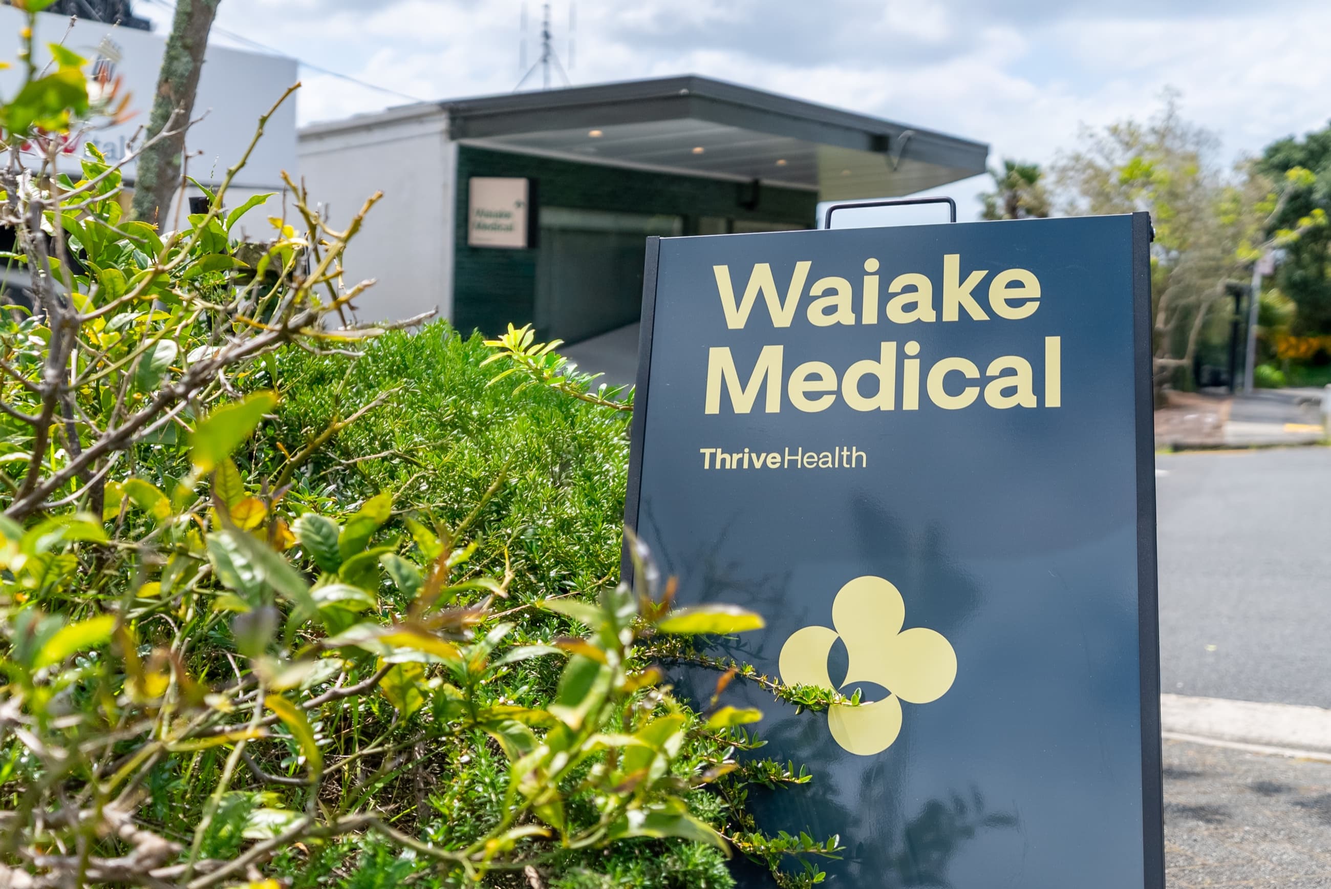 Waiake Medical monument sign surrounded by greenery