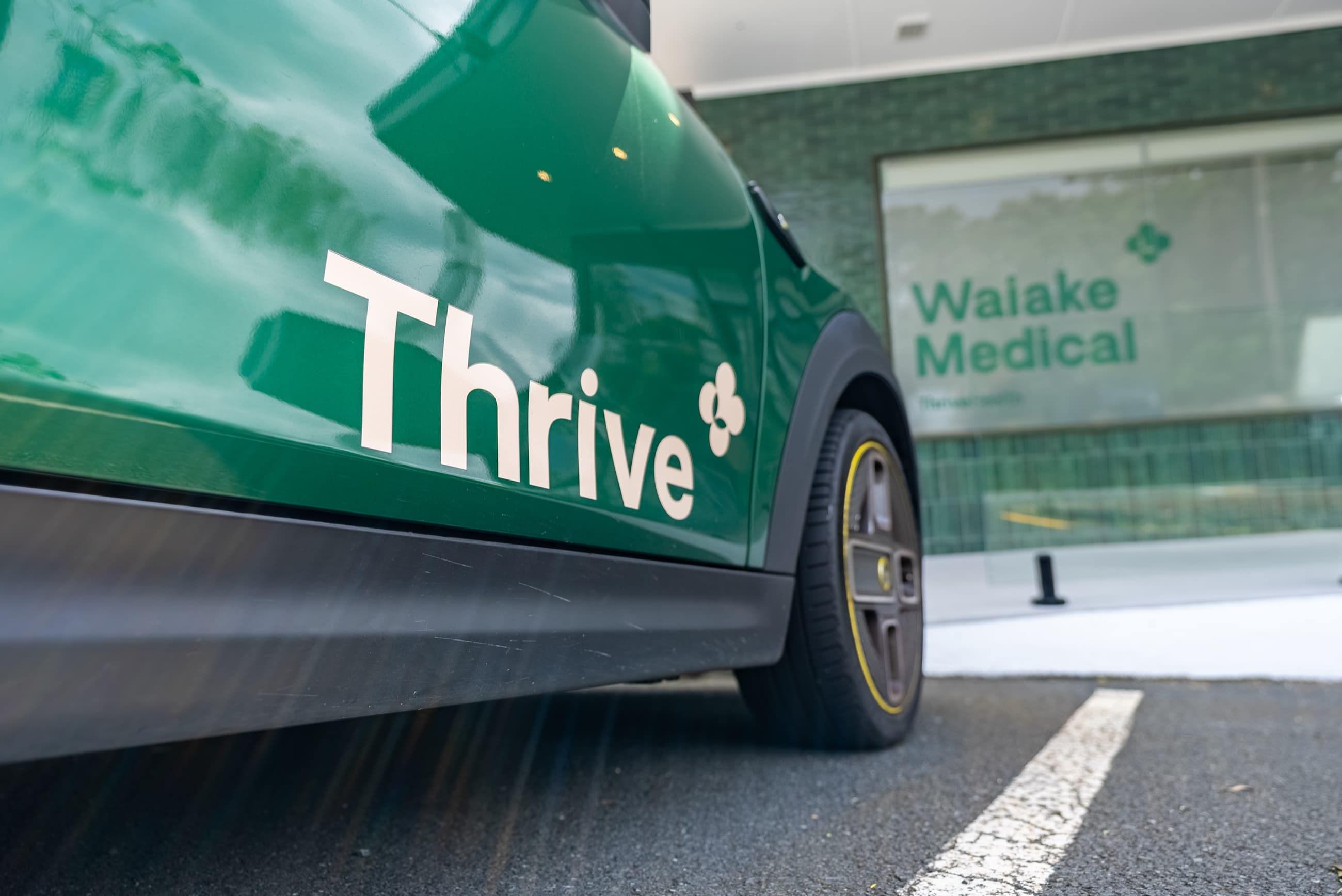 A Thrive-branded car parked outside the clinic