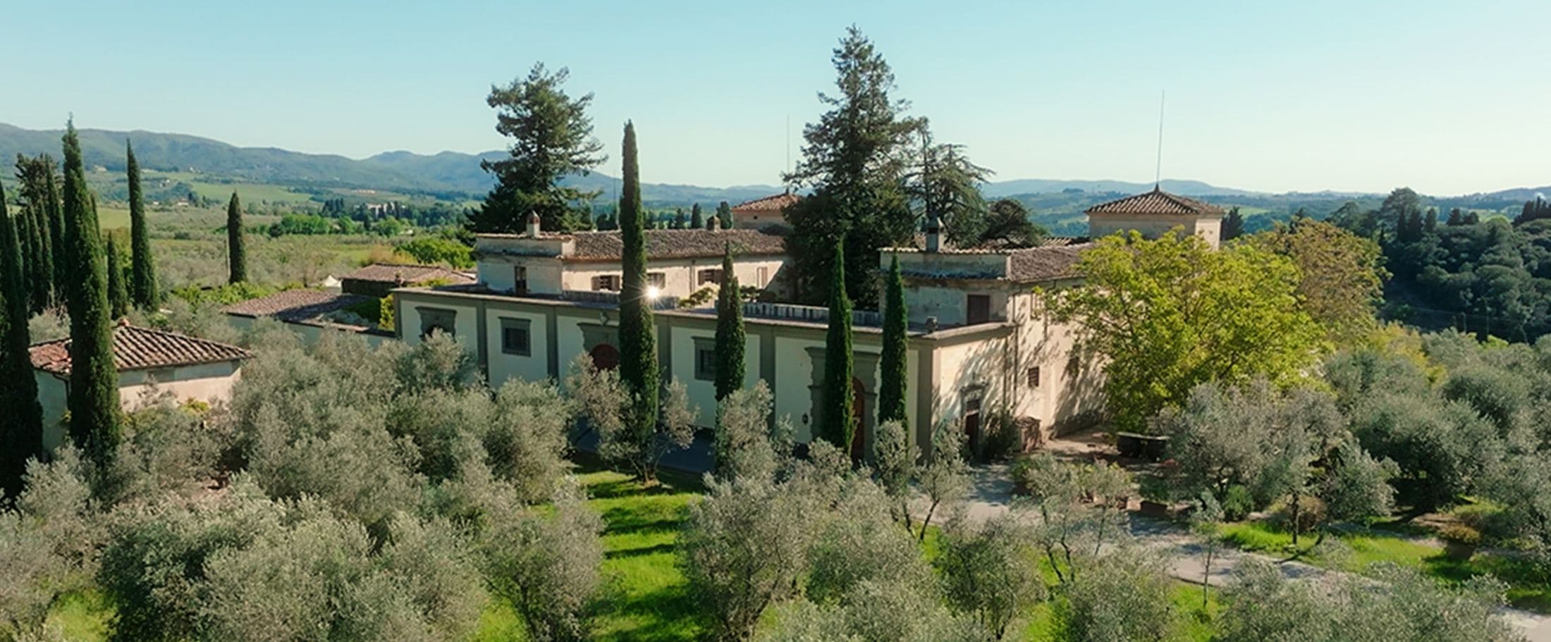 Tuscan villa surrounded by cypress trees
