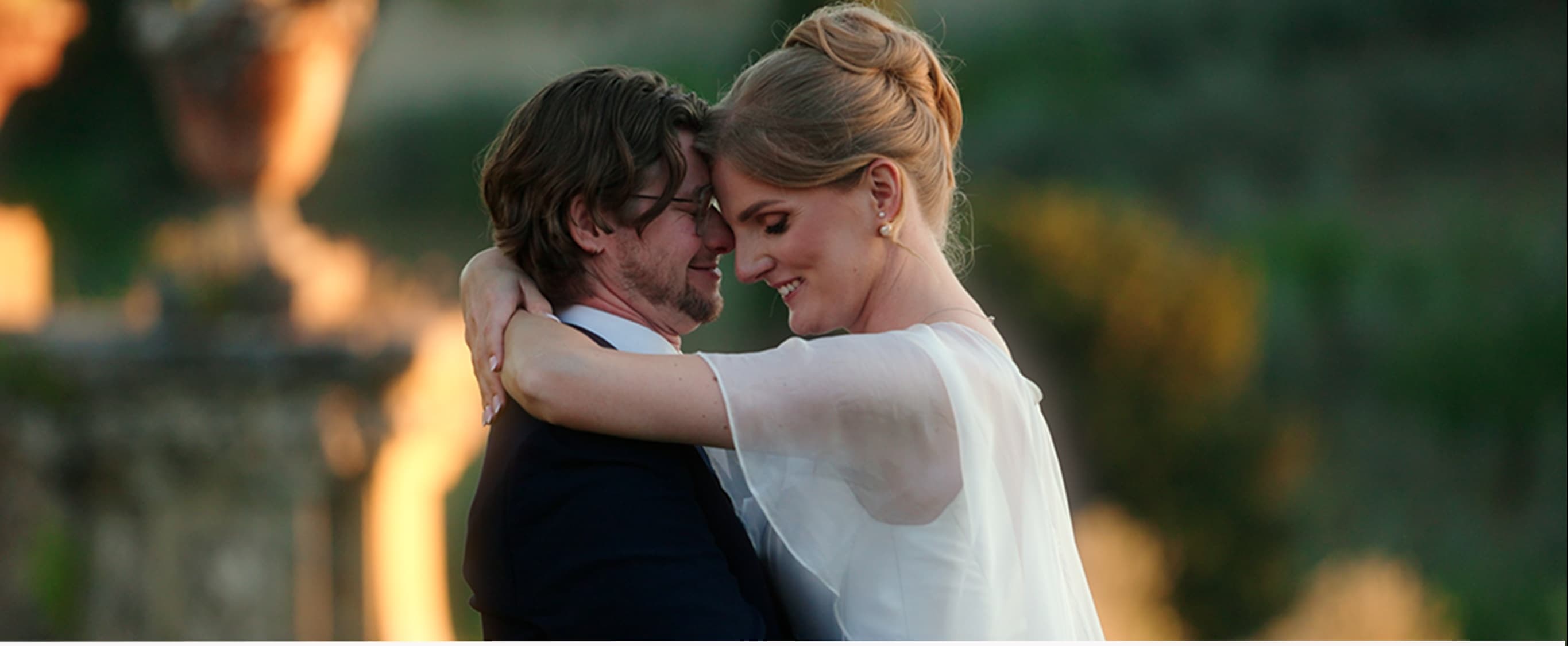 Bride and groom embracing in golden light