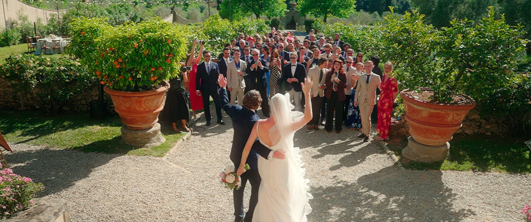 Bride and groom embracing under an archway