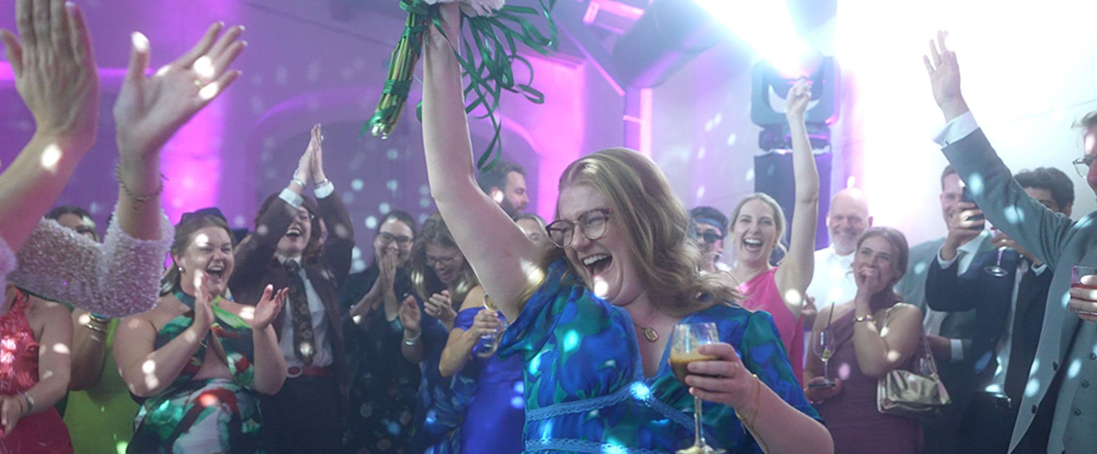 Guests dancing under string lights