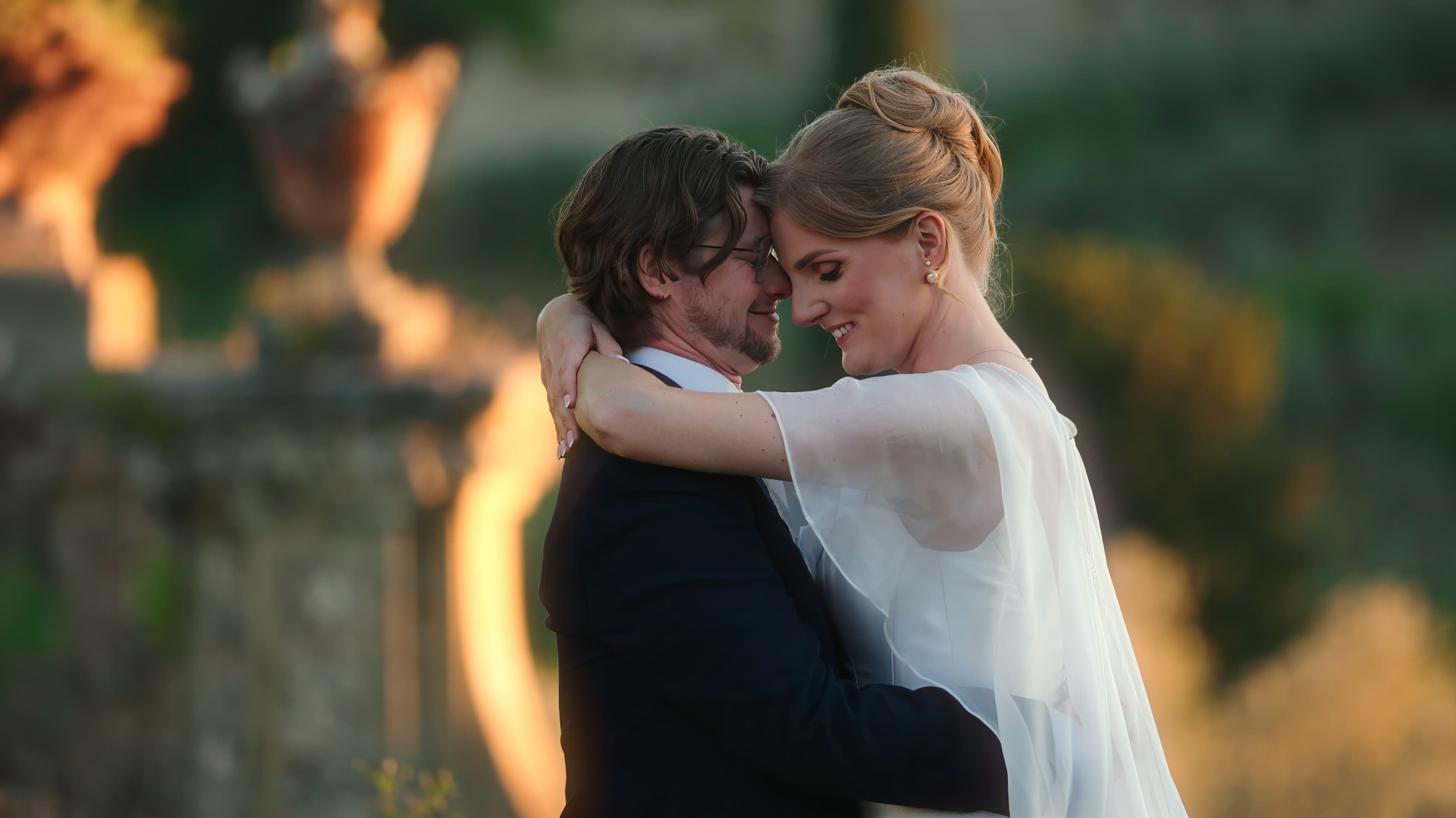 Bride and groom embracing in golden light