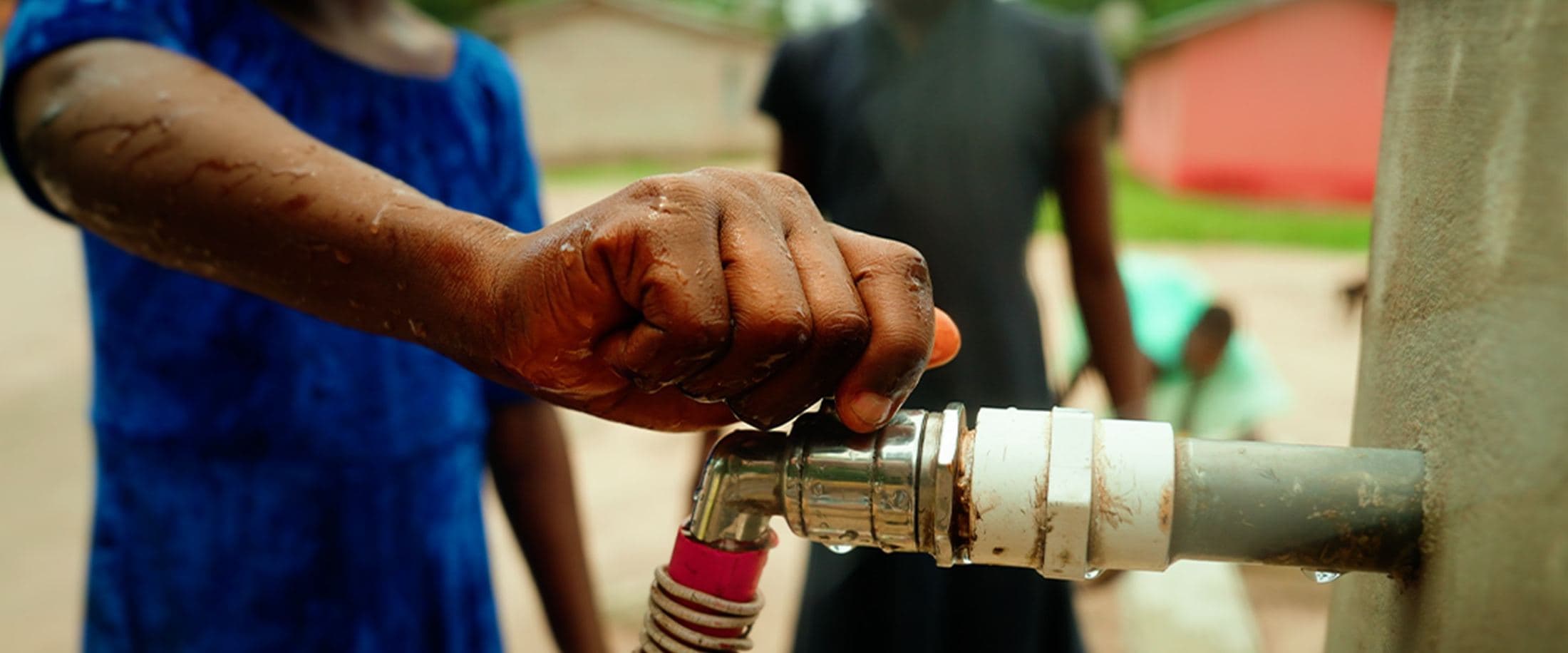 Hand under a running tap, Ghana
