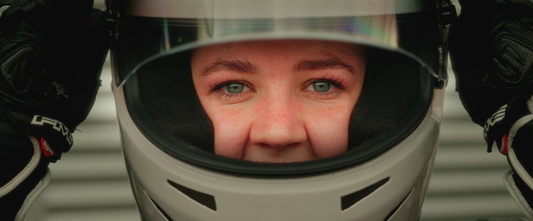 Close portrait through a racing helmet