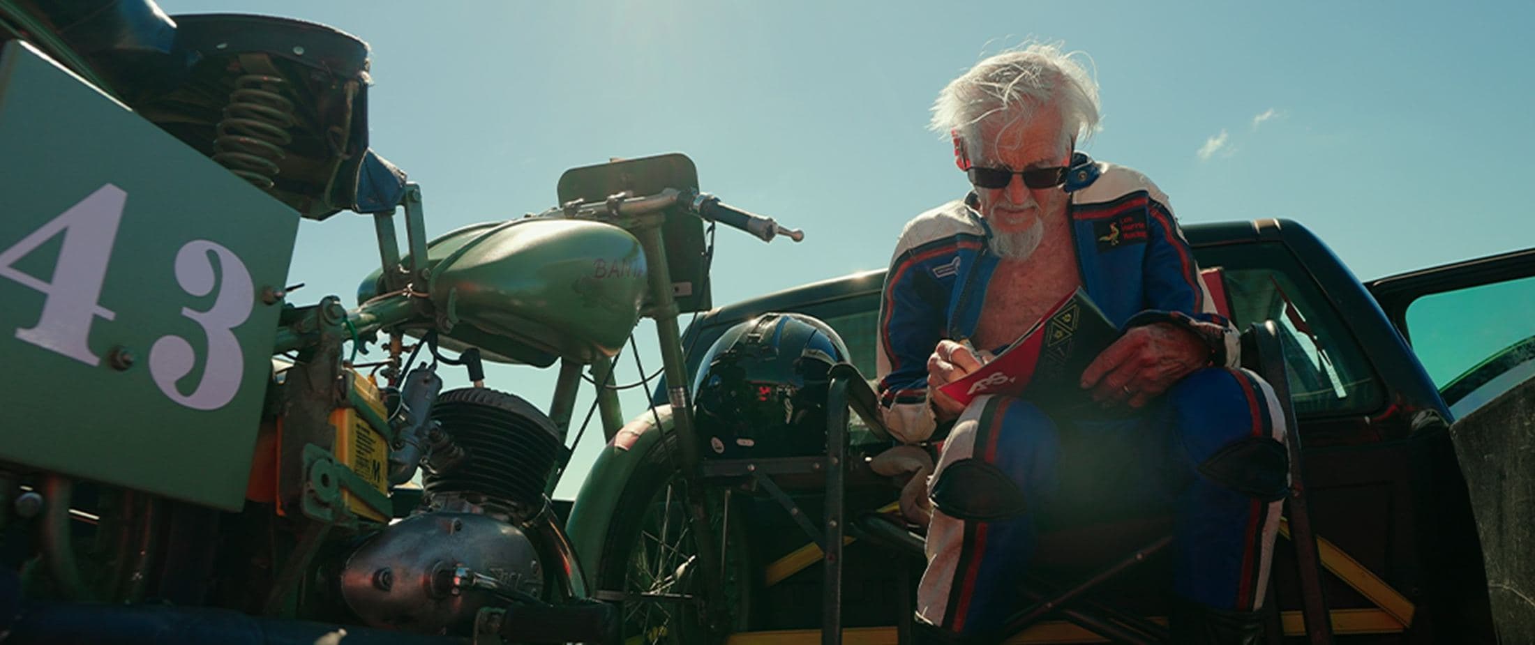 Rider resting on a vintage sidecar