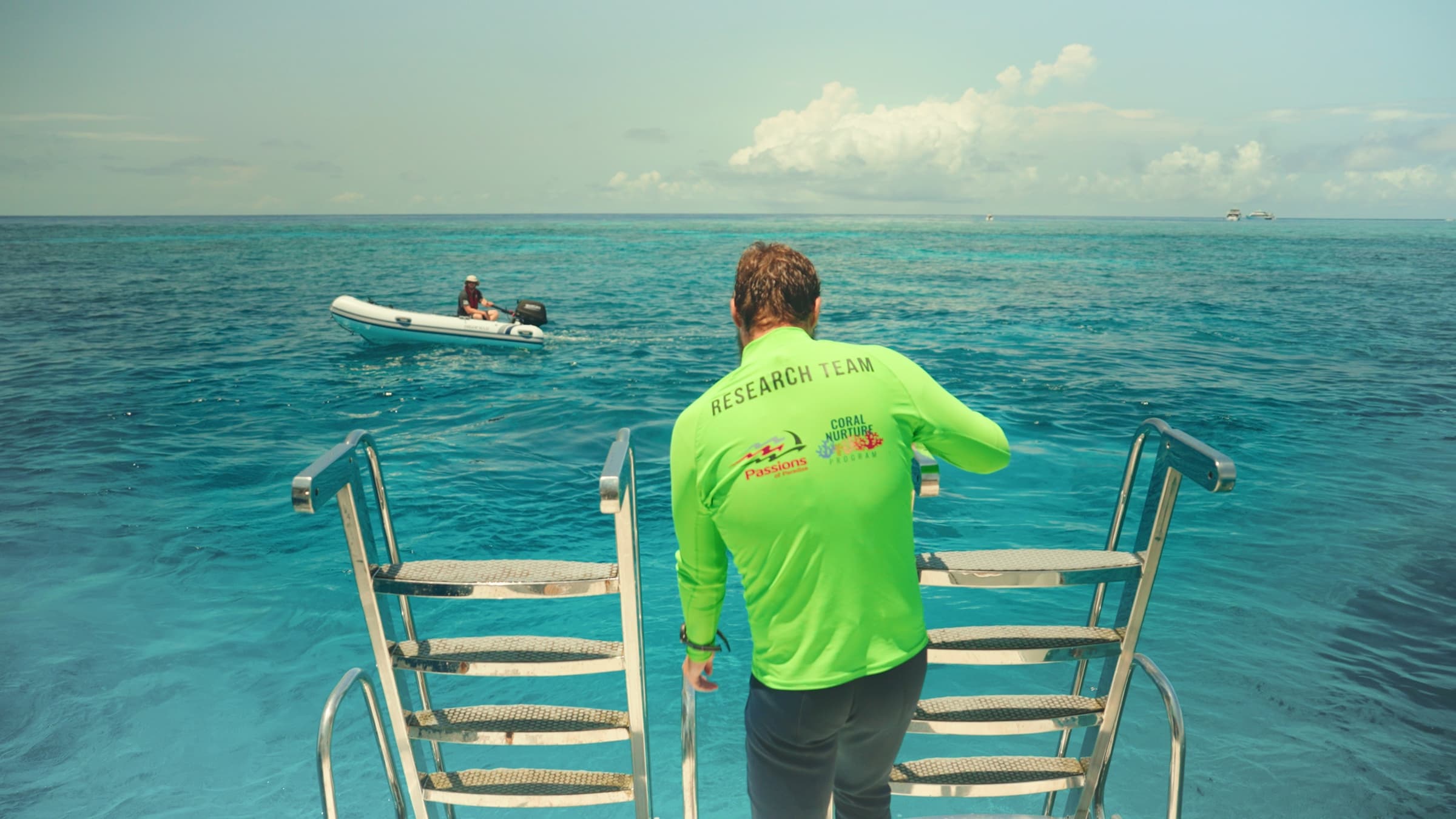A research team member looking out over the Great Barrier Reef from a boat