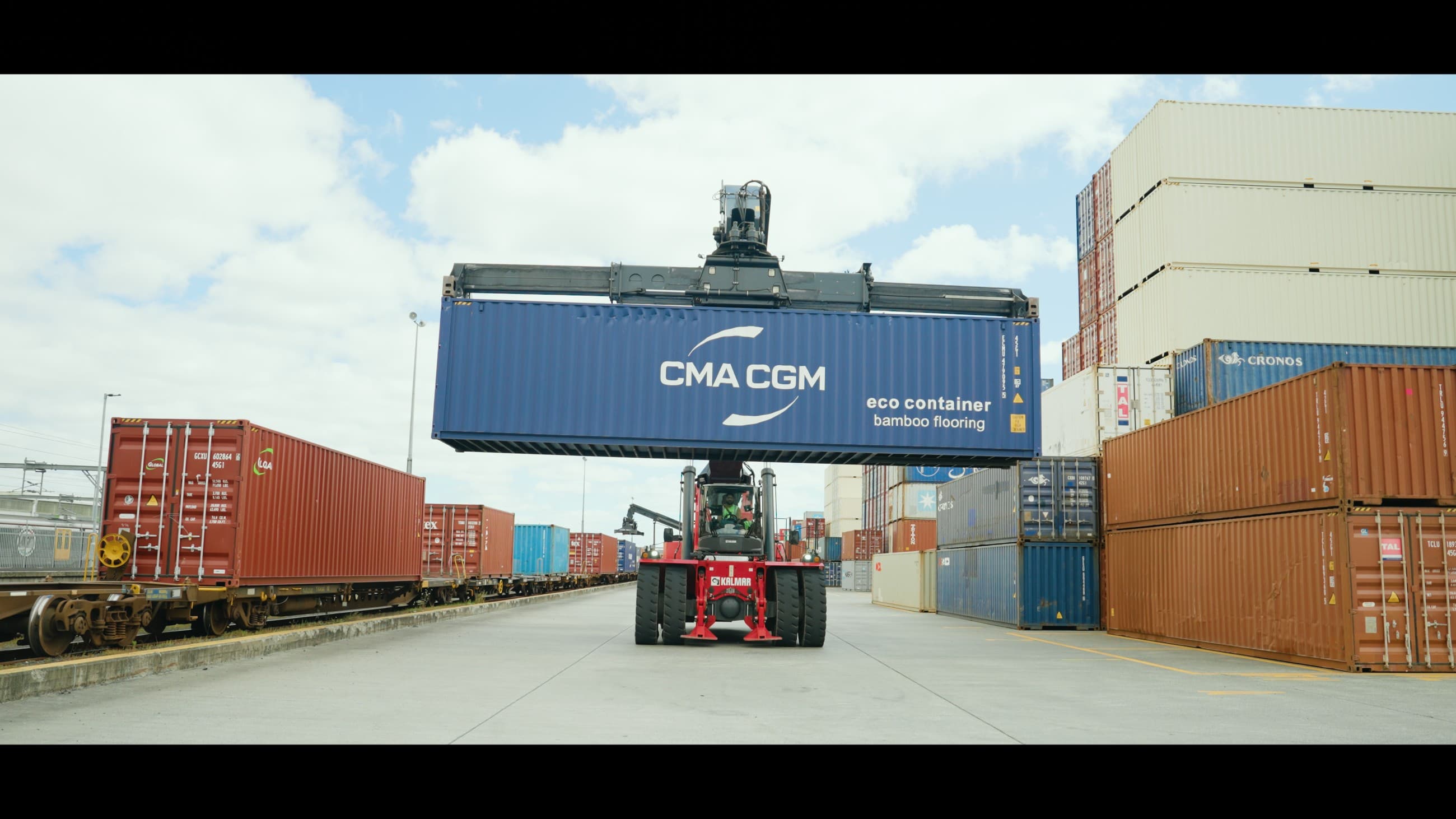 A container lifted directly above a rail wagon
