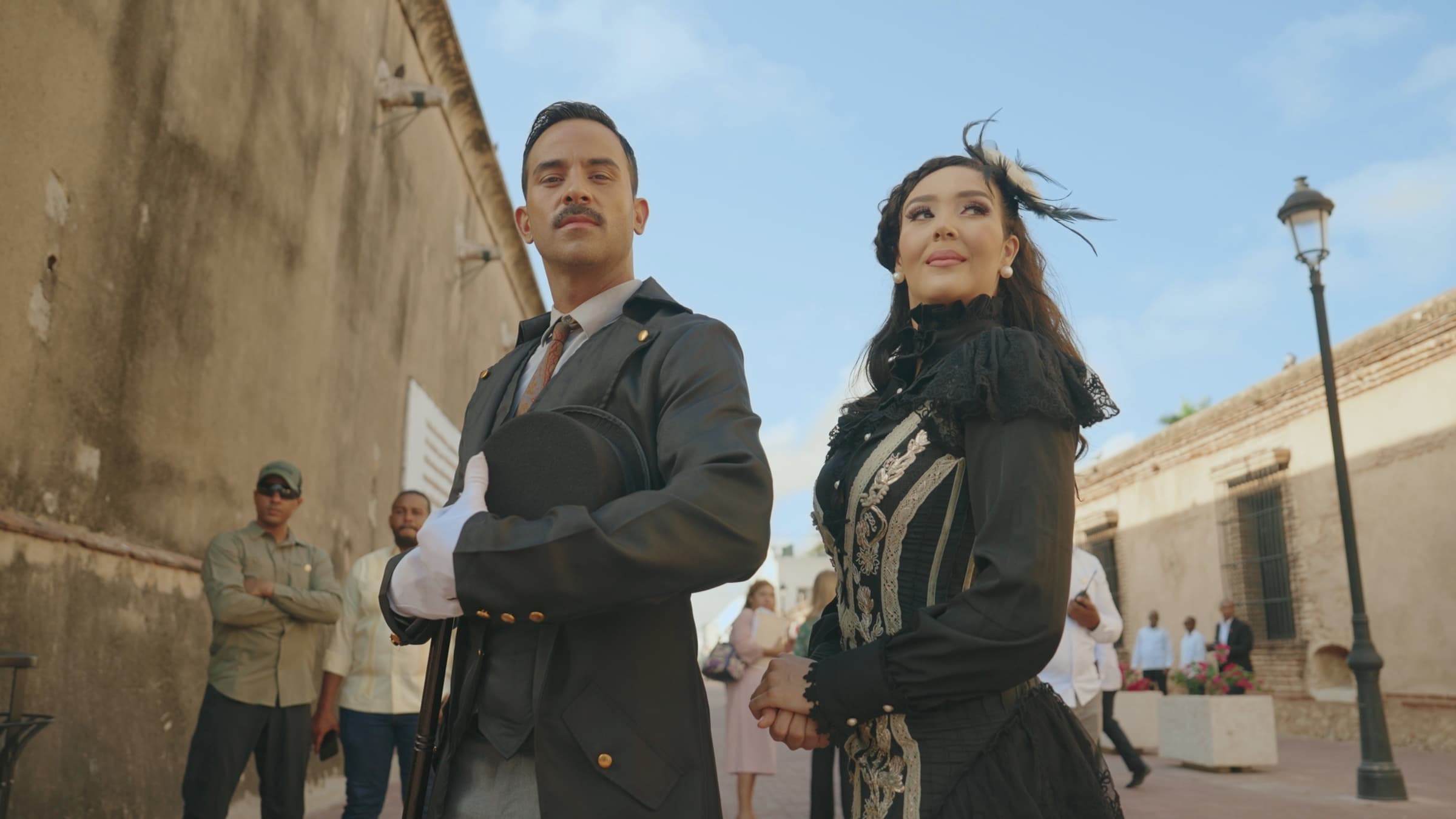 A couple in period costume standing in a colonial-era street in the Dominican Republic