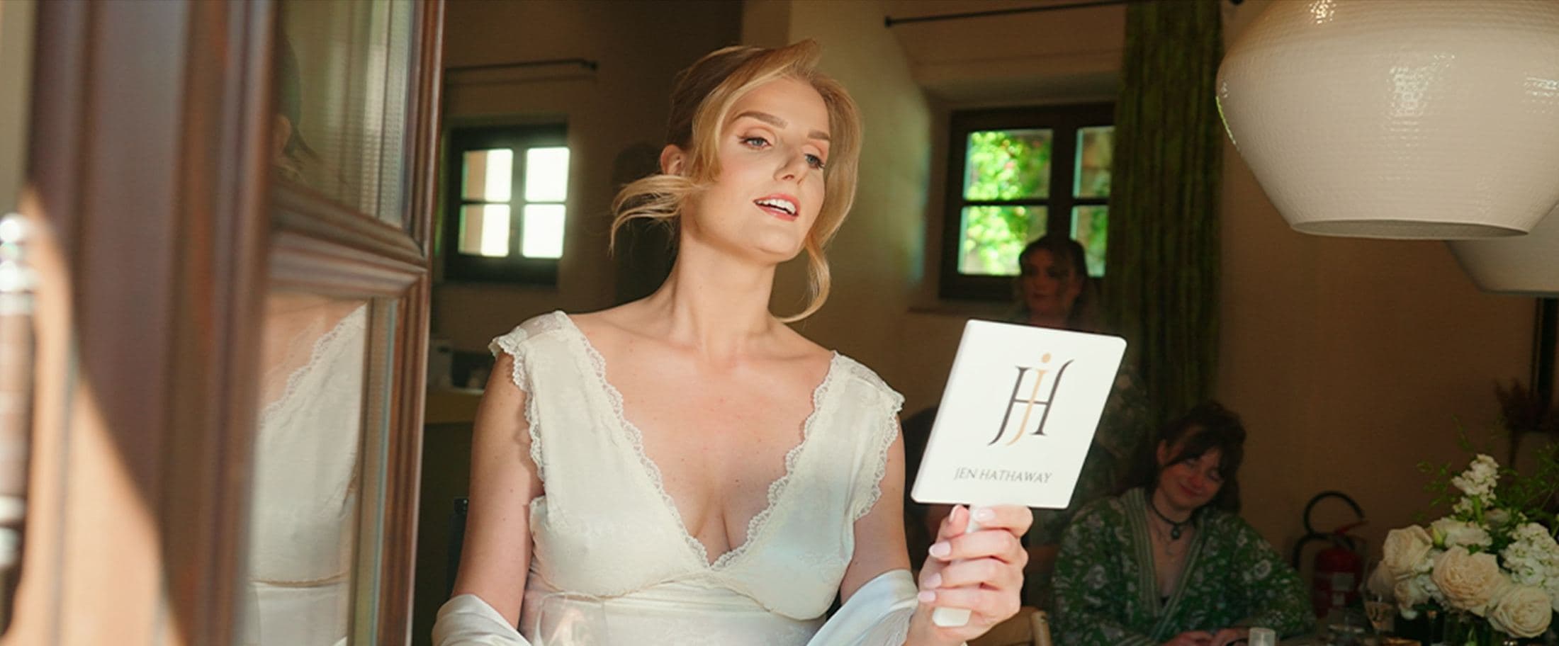 Bride getting ready, holding a room sign