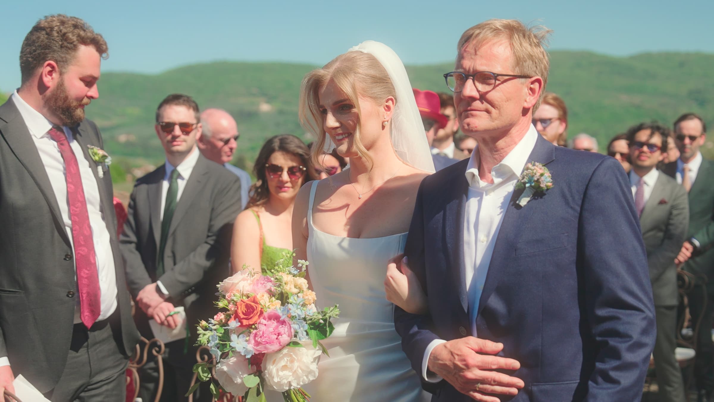 A bride walking down the aisle arm-in-arm with her father